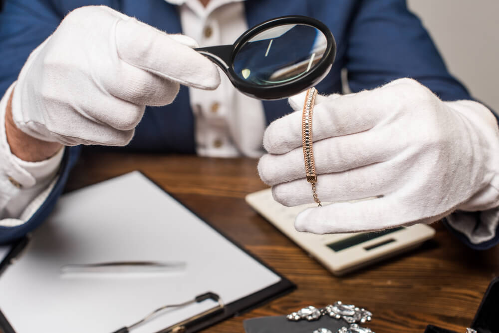 Jewelry appraiser examining fine jewelry piece